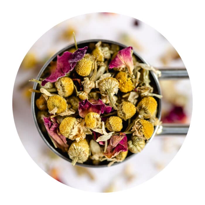 Leafy Bean Co blend called Chamo(s)mile, loose leaf tea in a metal tea scoop.